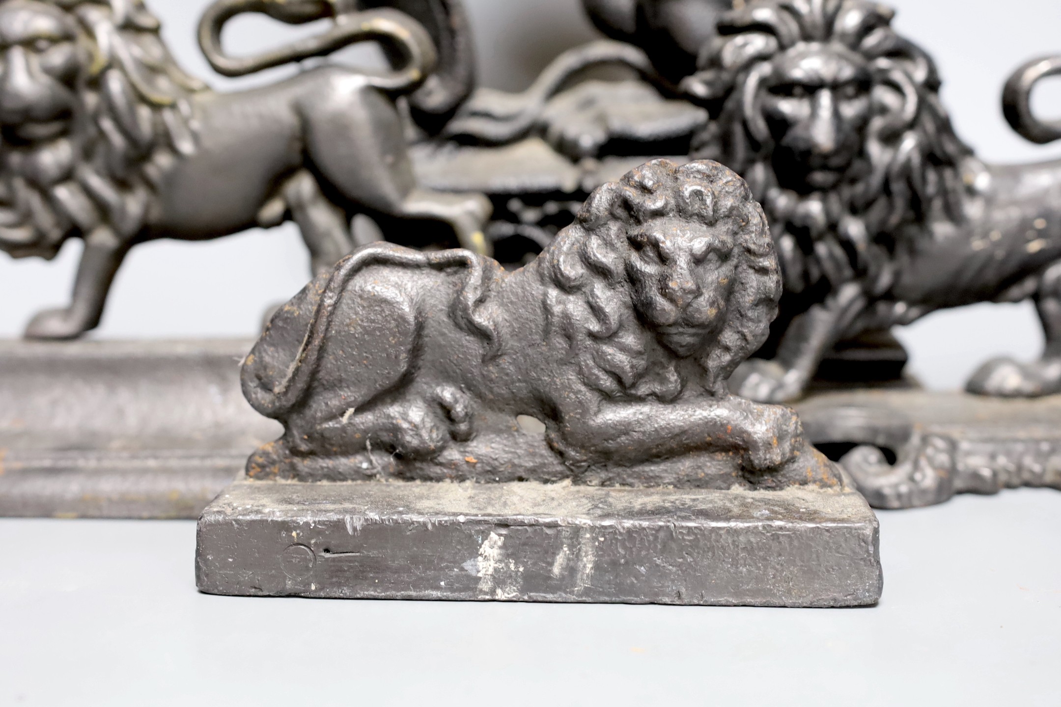 Four cast iron ‘lion’ door stops, 39cm